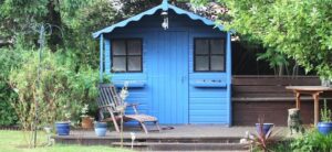 blue summer house in a garden