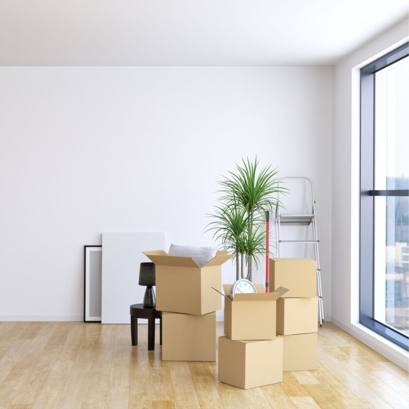 boxes packed up ready for moving near a big window 