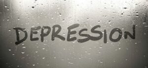 depression written on a misty rainy window