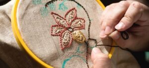 person in the middle of a beautiful embroidery