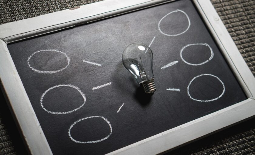Clear lightbulb on a black surface