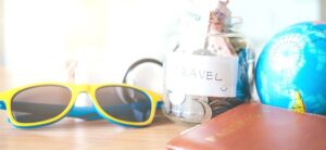 sunglasses travel money and a globe