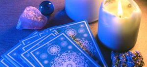 tarot cards candle and gems