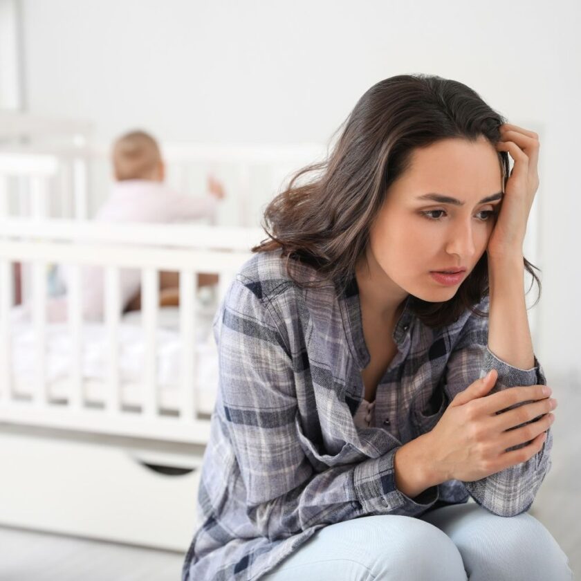 young woman suffering from postnatal depression at home