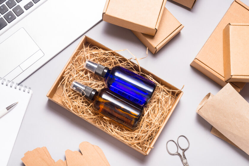 Set of brown and blue glass spray bottles packed in cardboard box