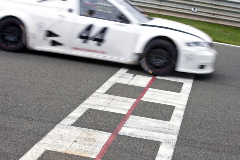 Race car crossing the finish line on a circuit