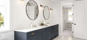 bathroom sink area with circular mirrors