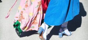 fashionable women walking along a road