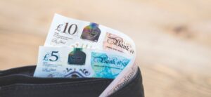 five and ten pound notes in a wallet