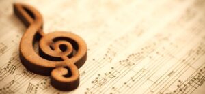 wooden treble clef on sheet music
