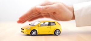 hand over a yellow car showing protection
