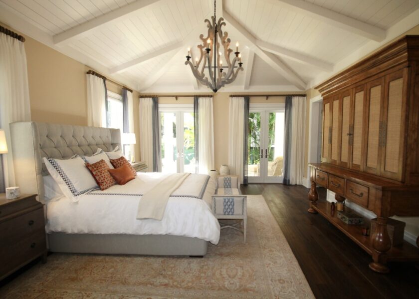 upholstered bed near a cabinet
