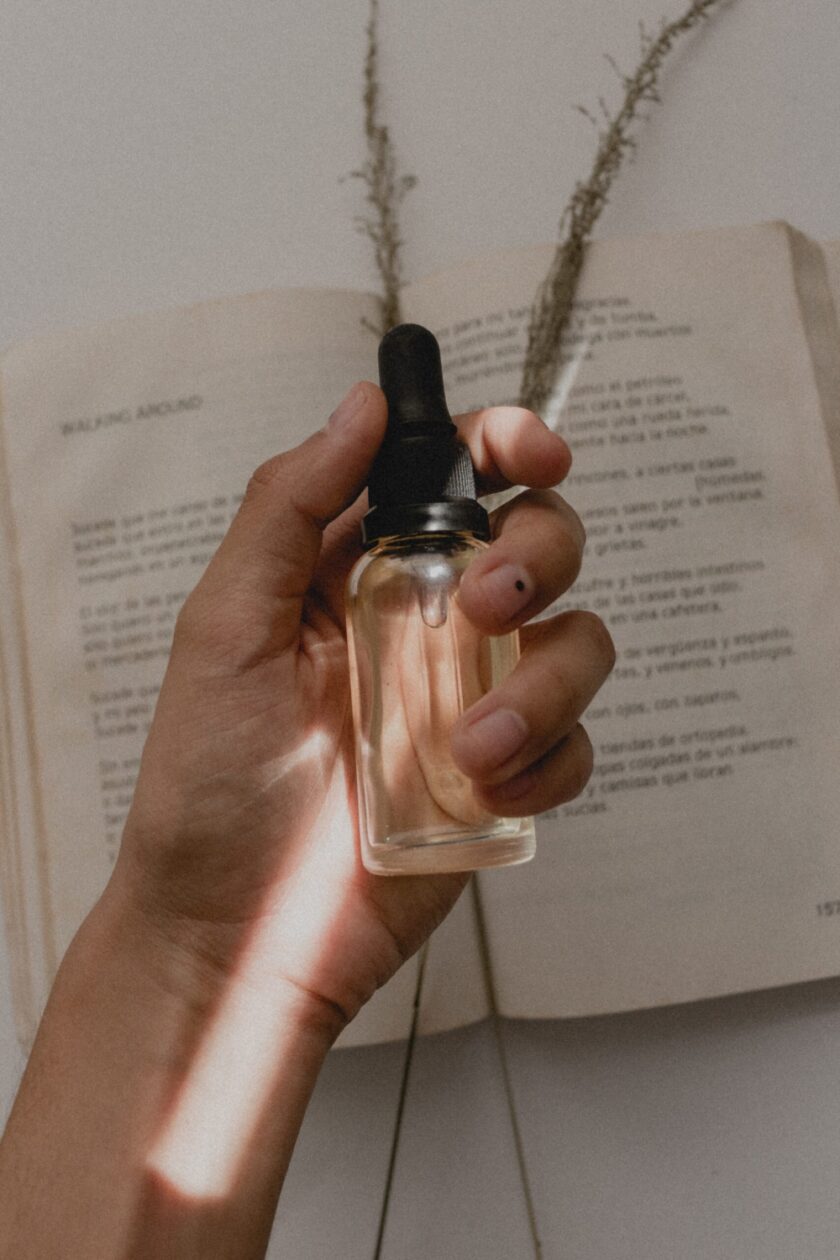 person holding a clear spray bottle