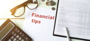 financial tips written on a piece of paper surrounded by glasses and calculator