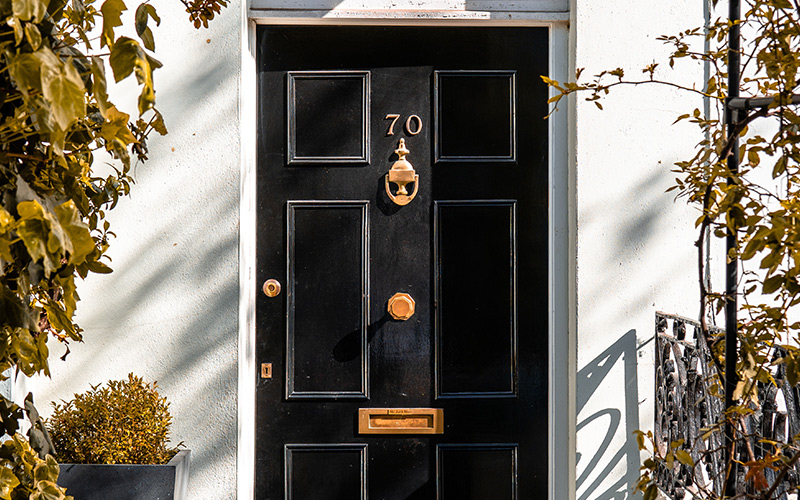 Closed black wooden front door