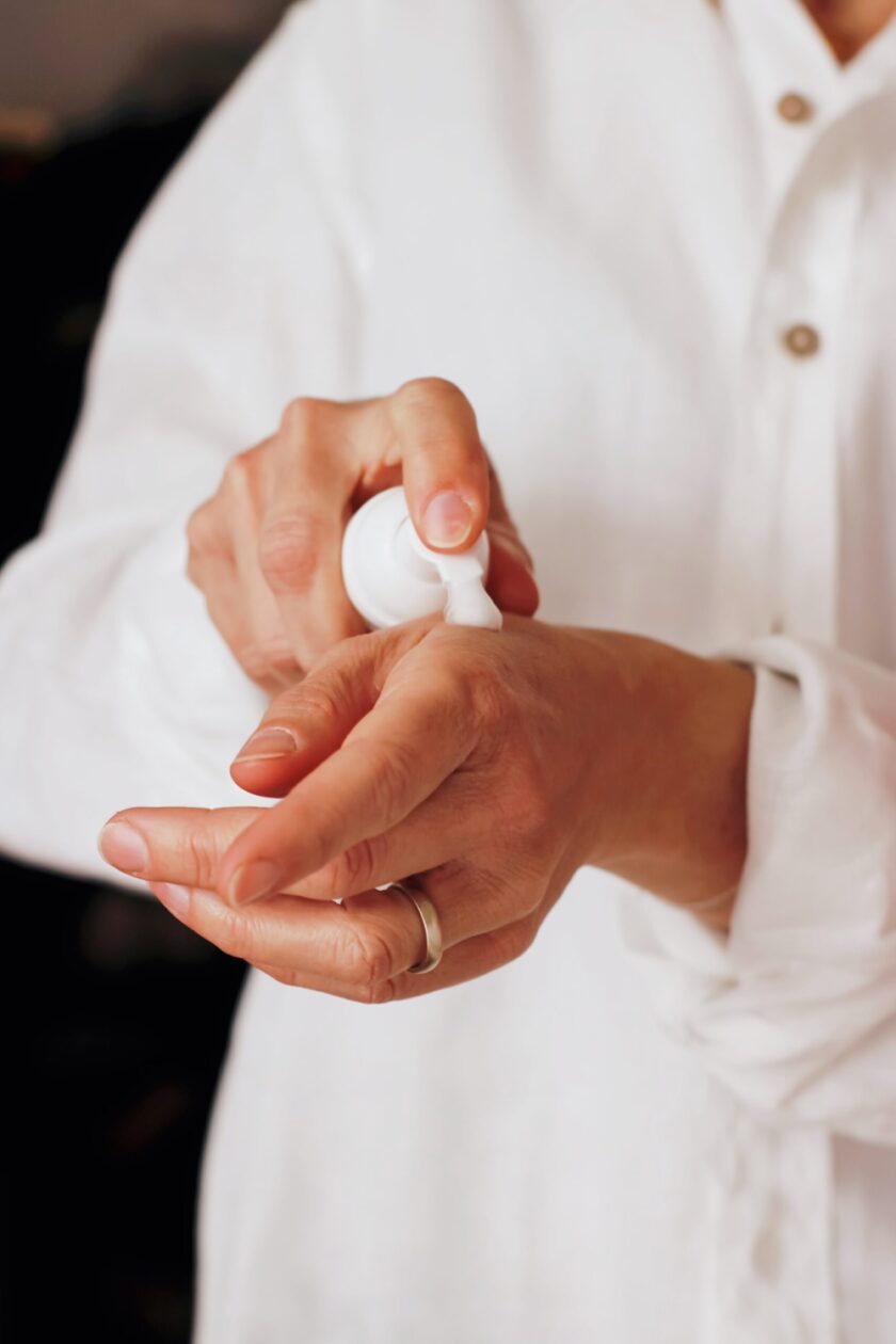 Person squirting some moisturiser on to their wrist