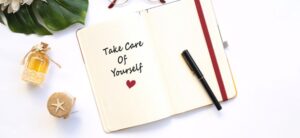 note book which says take care of yourself image licensed via canva pro and copyright via Getty Images and Hazal Ak