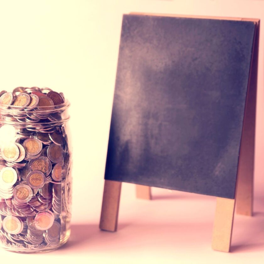 pot of coins next to a black board