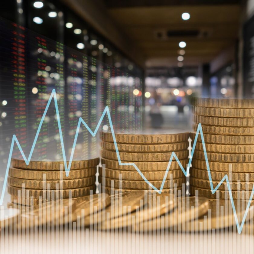 coins with graph in front of it showing investing