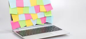 laptop with post it notes over it