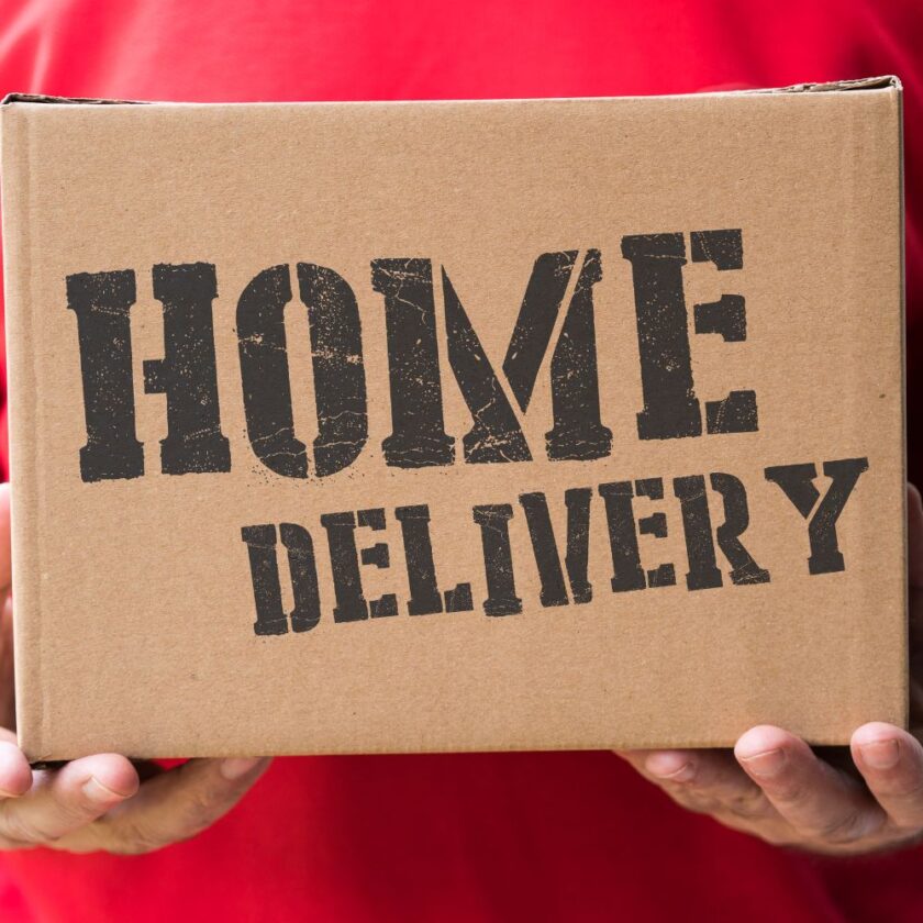man holding a box that says home delivery