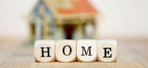 home written out in wooden bricks with a house shaped item