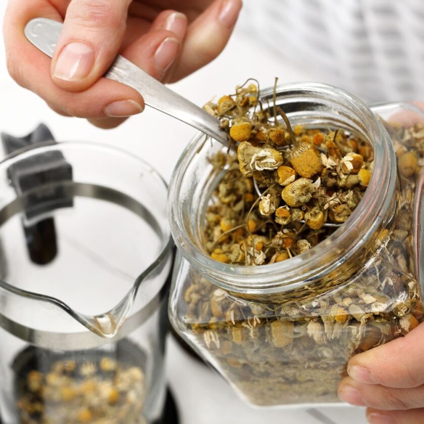 person preparing chamomile tea