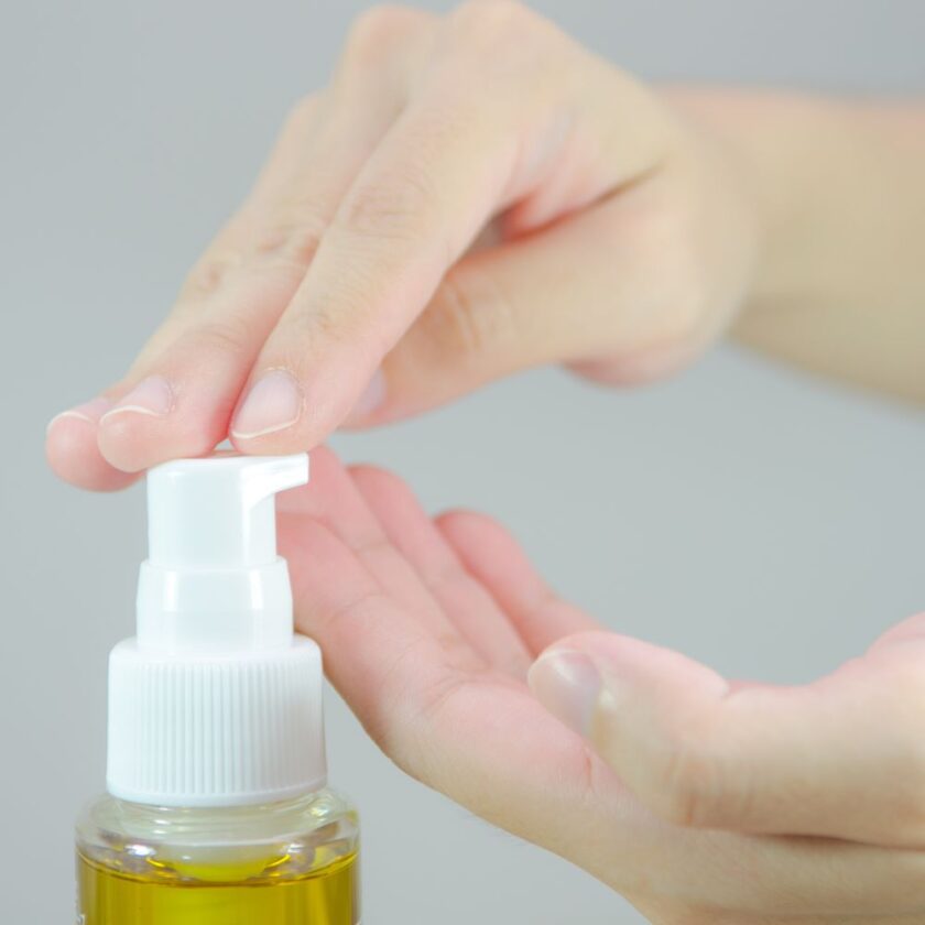 someone putting cleansing oil onto their hand