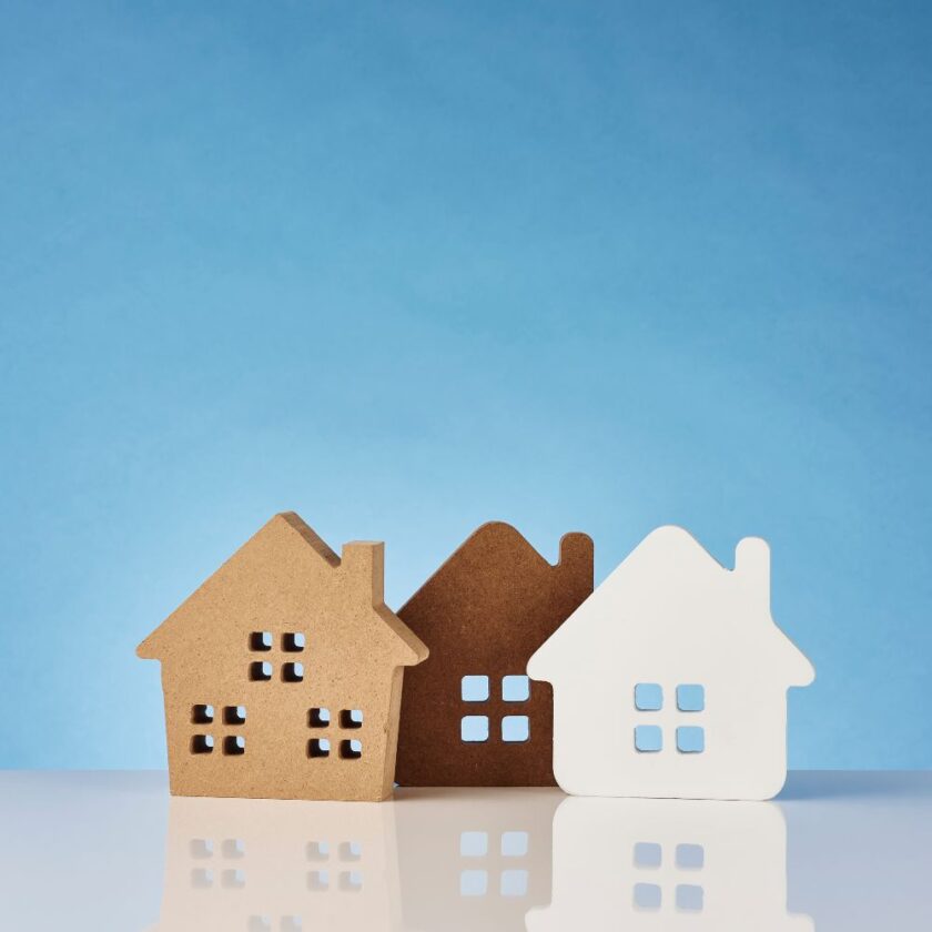 three house shaped blocks against a blue backdrop