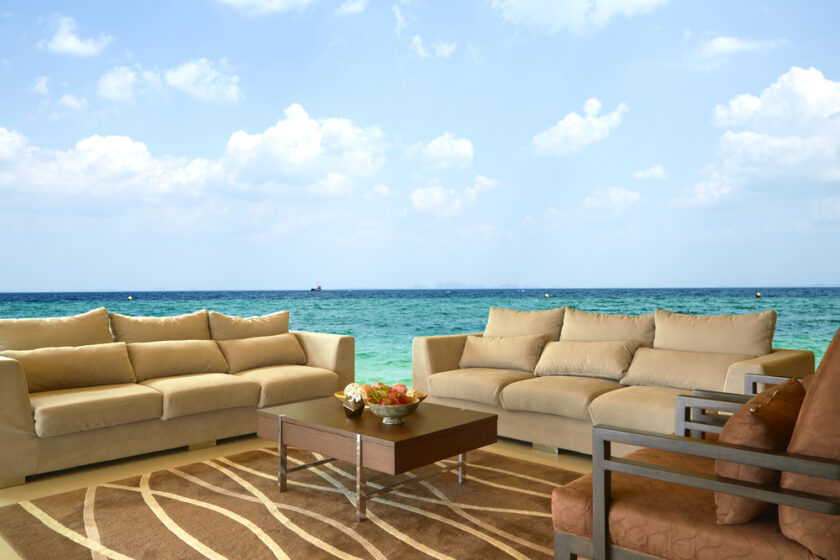 endering of a sofa in front of wall mural ocean, Interior of a modern house, comfortable living room
