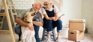 couple with a dog working on a home remodel