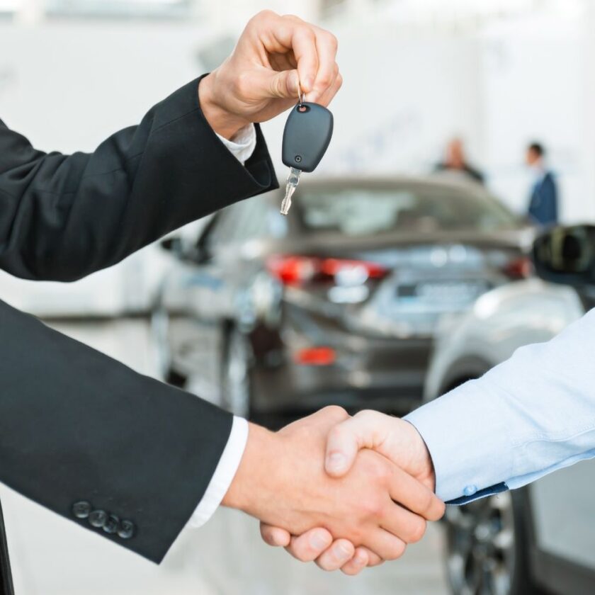 person handing over car keys to a driver