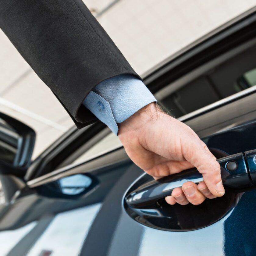 person with his hand on a car door