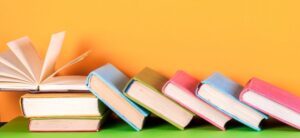 colourful books against a yellow backdrop