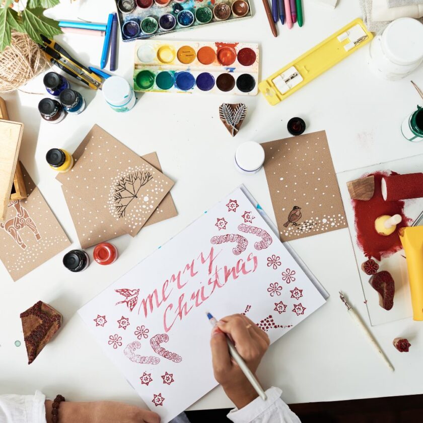 person making handmade Christmas cards