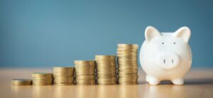 pound coins by a piggy bank