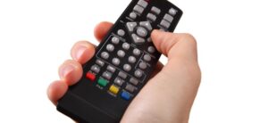 tv remote control in a persons hand
