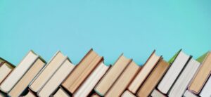 Many Books Piles. Hardback books on wooden table.