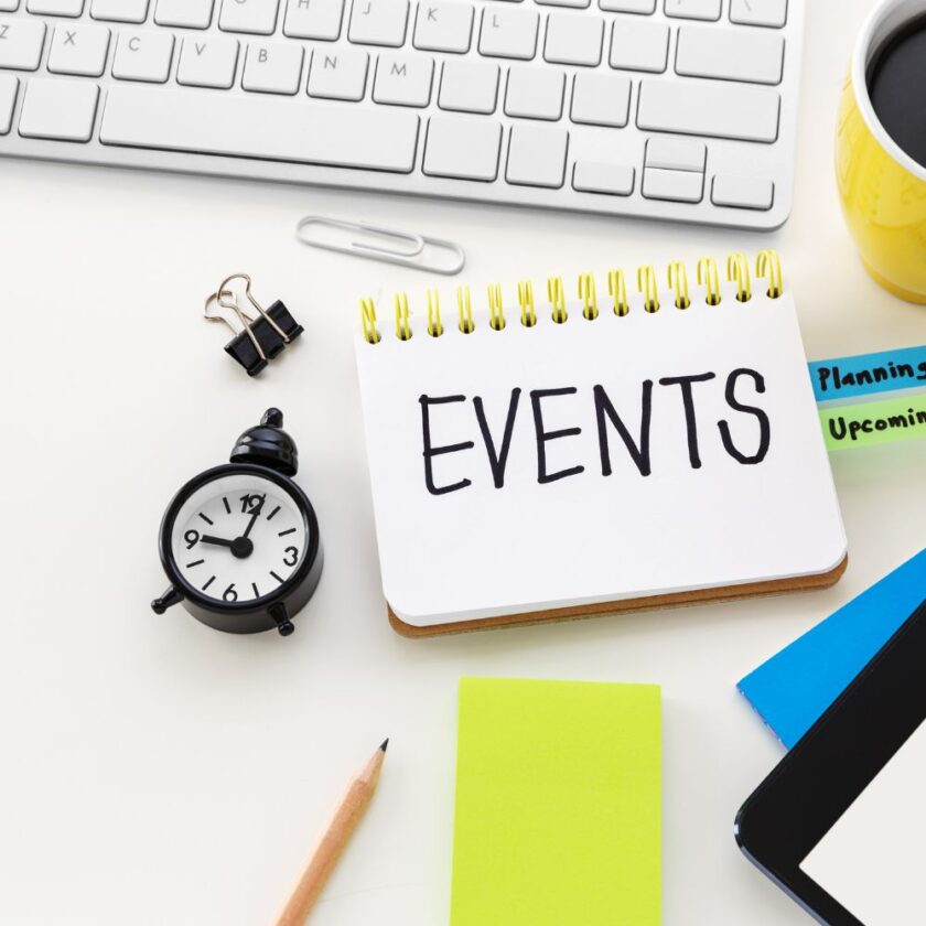 events written on a notepad next to a small clock and keyboard