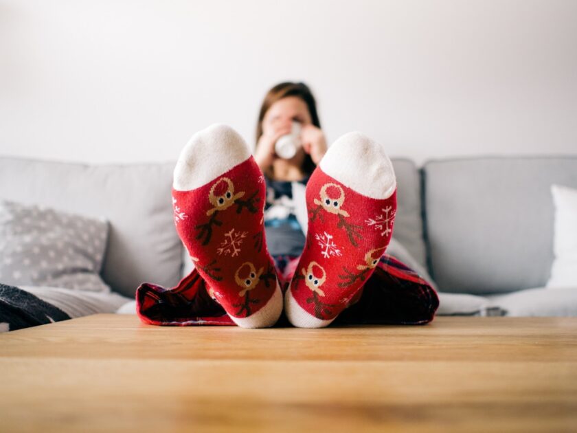 woman with her feet up in a living room being cosy
