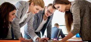 group of people standing around planning an event