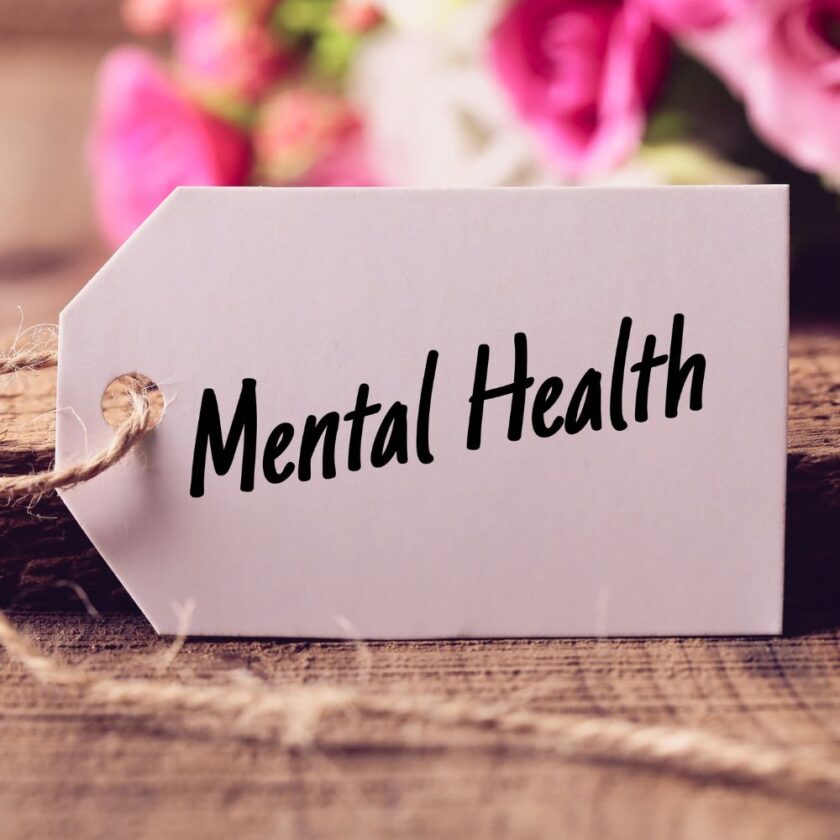 mental health written on a tag with flowers in background