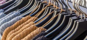 range of jumpers hanging on a rail