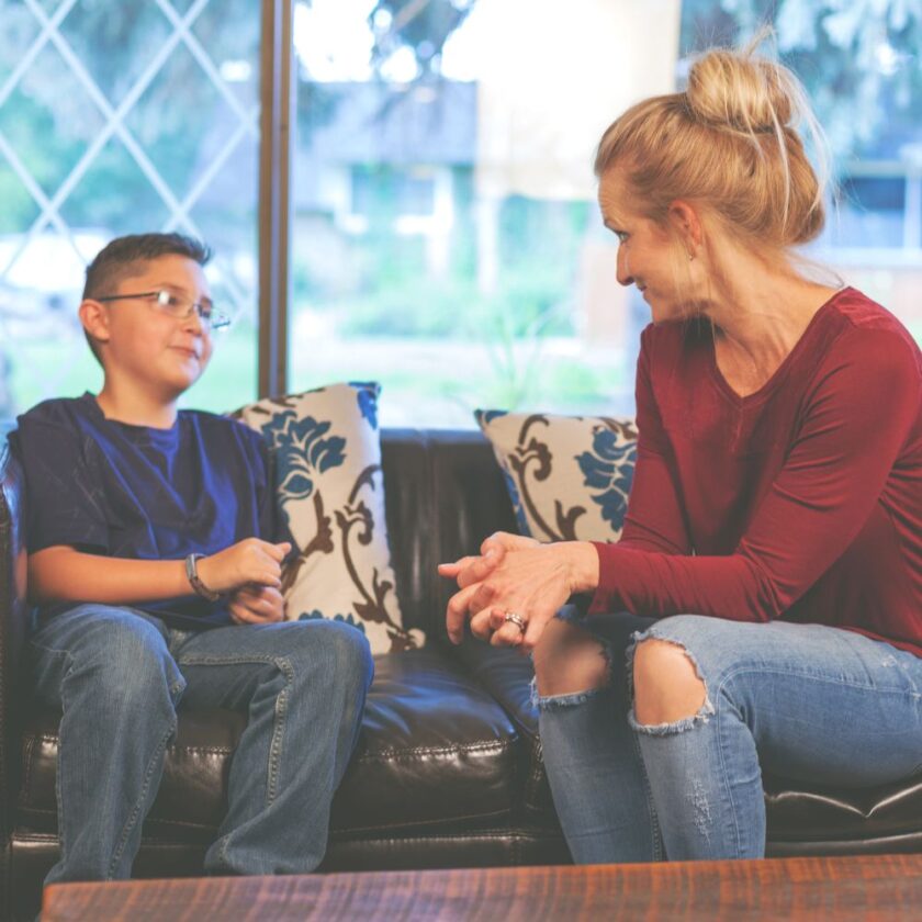 woman and child sat on a sofa talking