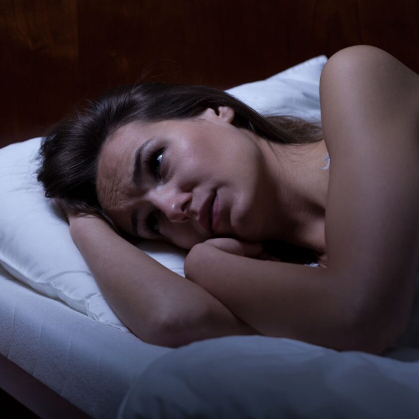 woman laying in bed who cannot sleep