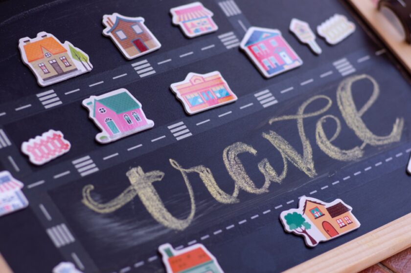 The word travel surrounded by small images of holiday homes