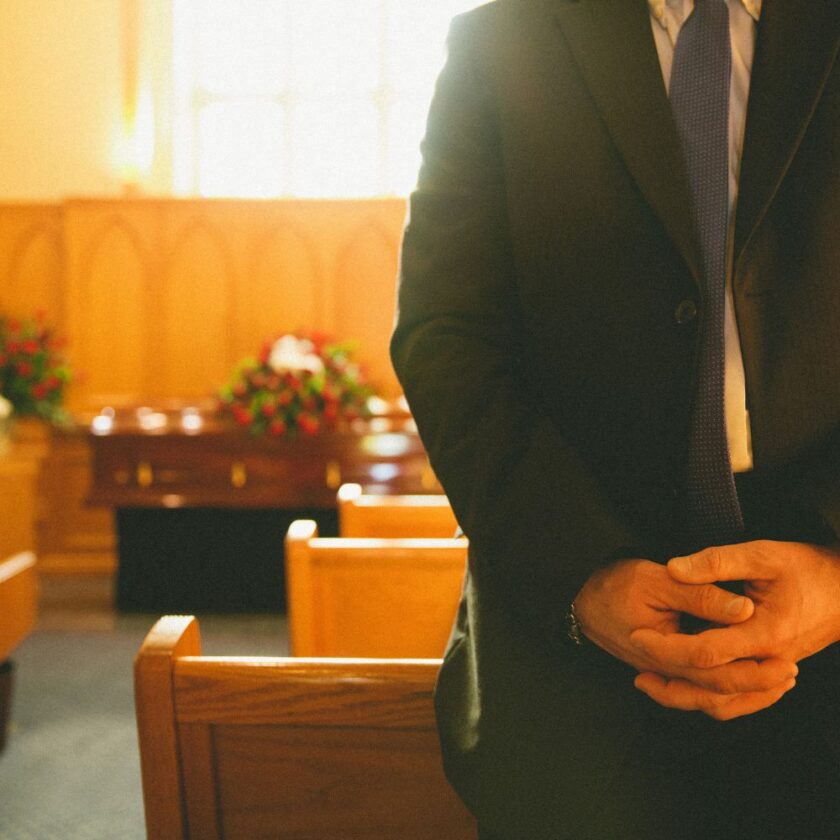 person in suit at a funeral service