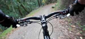 person riding a mountain bike down a trail