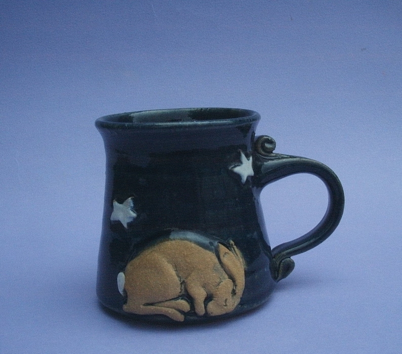Mug with a little hare sleeping under the stars from westgreenpottery on etsy