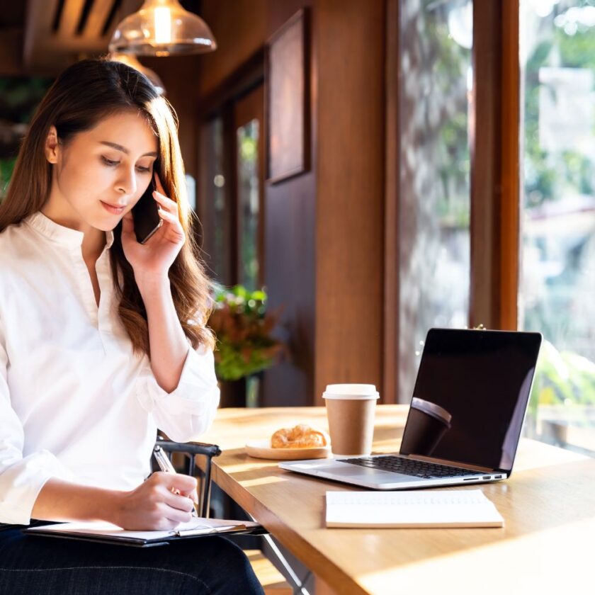 person sat at a table working on their laptop